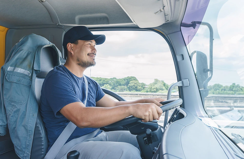 Driver behind the wheel of a delivery truck