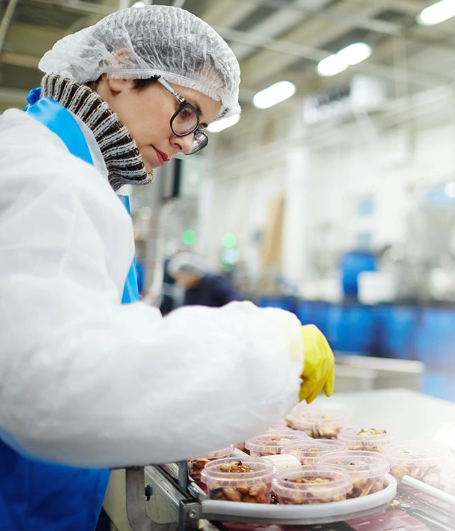 Food production associate on a packing line